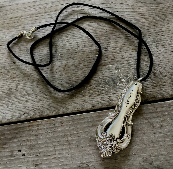 Serving spoon handle necklace stamped BLESSED hangs from long black leather cord
