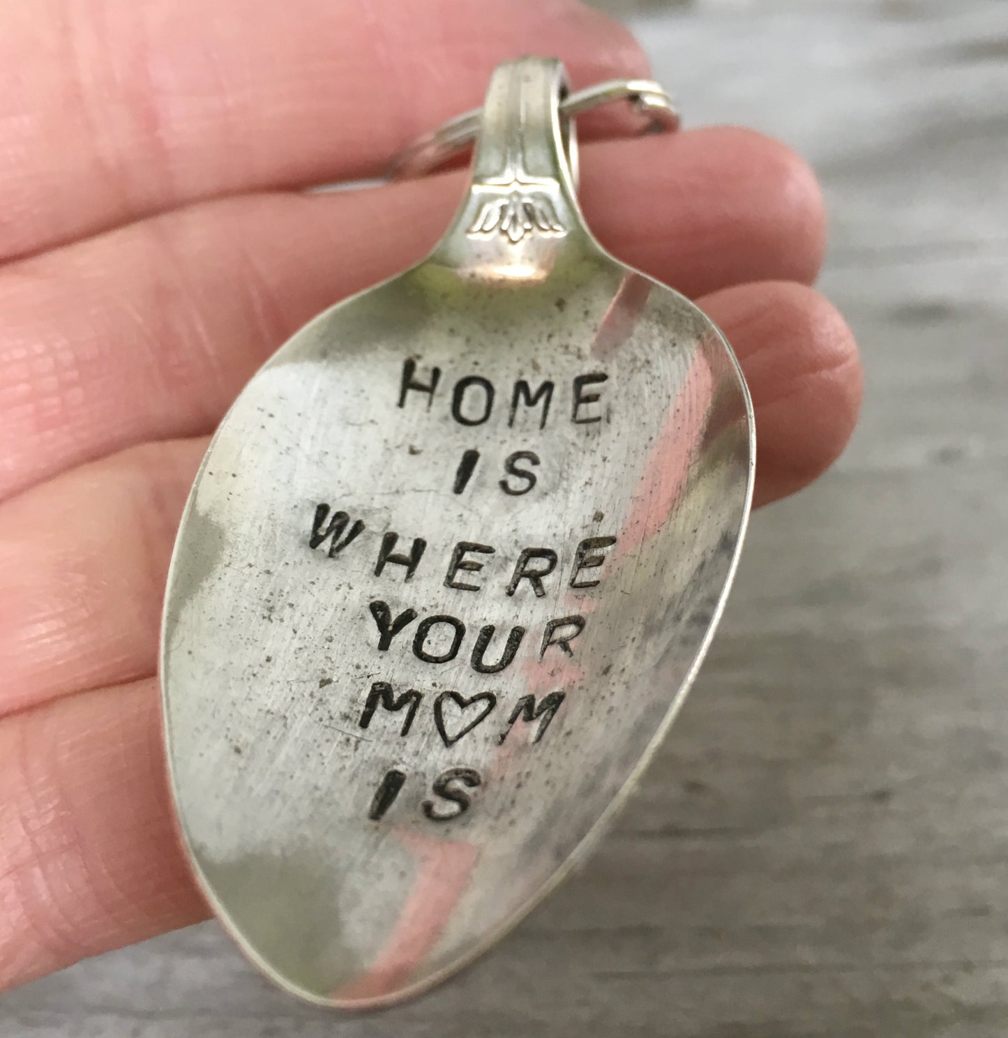 Home is where your mom is hand stamped spoon keyring shown in hand for size