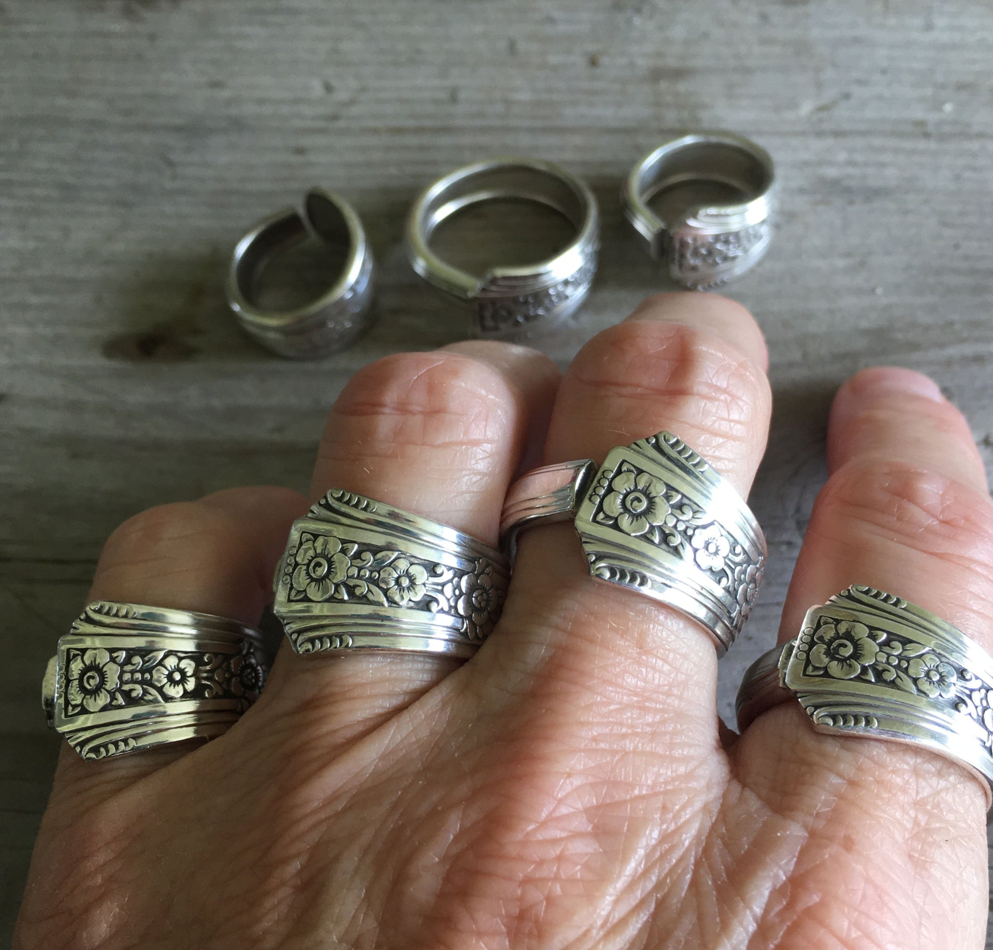 four Fortune pattern spoon rings shown on a hand - Spoon Ring - handcrafted from upcycled vintage silverware - Laughing Frog Studio