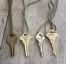 Four hand stamped giving key necklaces