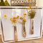 Collection of Queen Bess Knife vases with magnets displayed on a metal surface each holding a bouquet of wildflowers