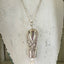 Knife Bell Necklace from Avalon Cabin Pattern accented with cultured pearls shown hanging