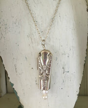 Knife Bell Necklace from Avalon Cabin Pattern accented with cultured pearls shown hanging