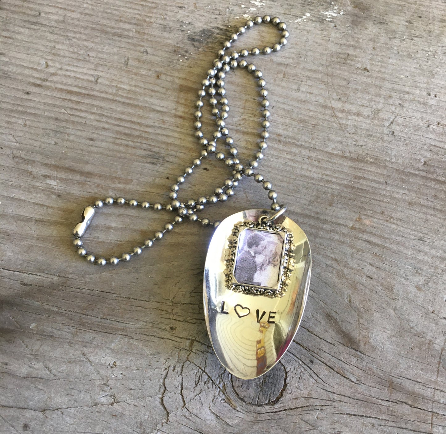 LOVE hand-stamped spoon necklace with heart detail and pewter frame showing layerable nostalgic style, upcycled silverware jewelry