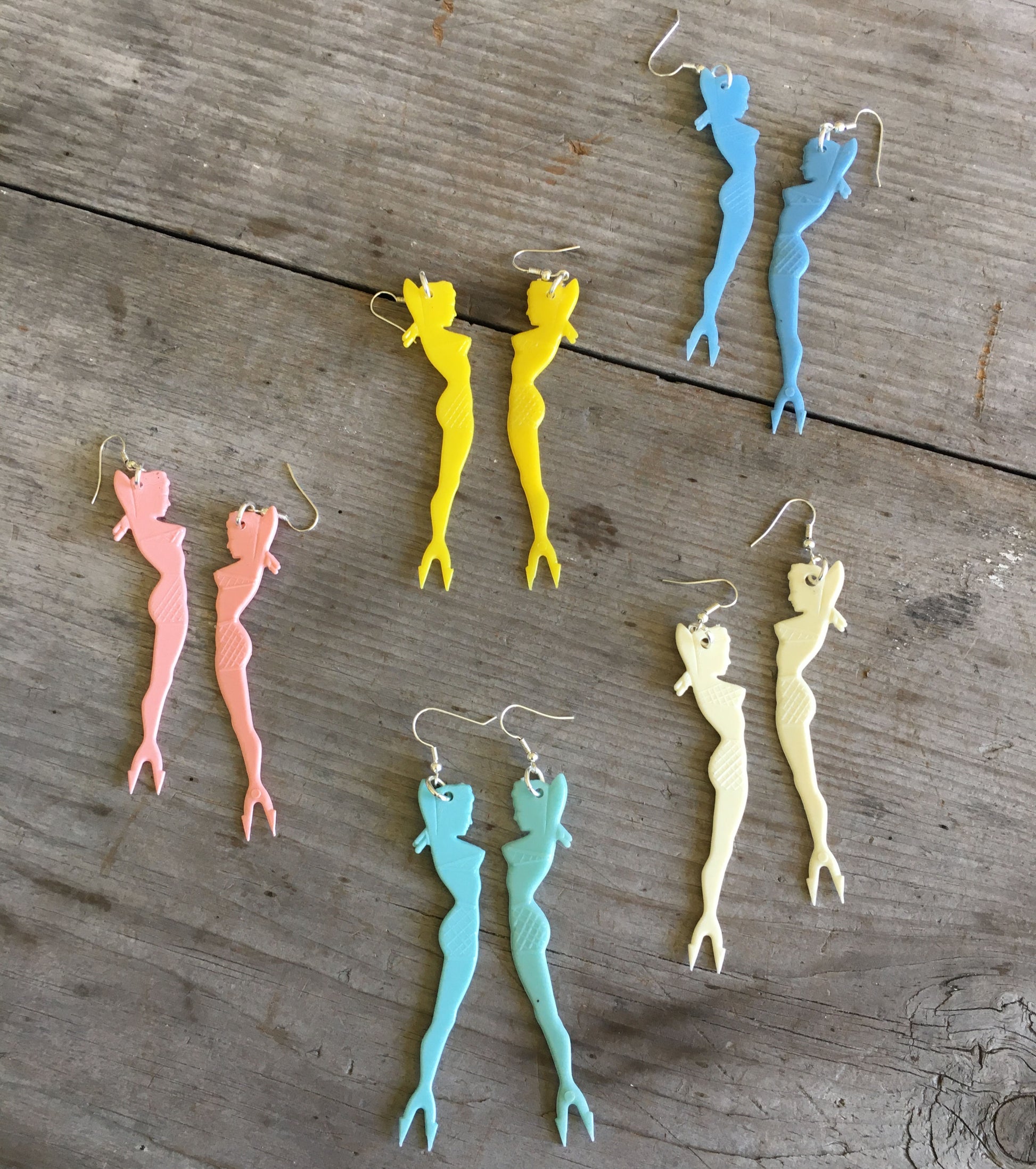 Collection of pinup girl cocktail fork earrings in various colors showing 1950s retro style options