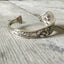 Reed and Barton Poppy pattern cuff bracelet side view showing floral detail - handcrafted from upcycled vintage silverware - Laughing Frog Studi