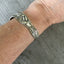 Reed and Barton Poppy pattern cuff bracelet worn on wrist - handcrafted from upcycled vintage silverware - Laughing Frog Studio