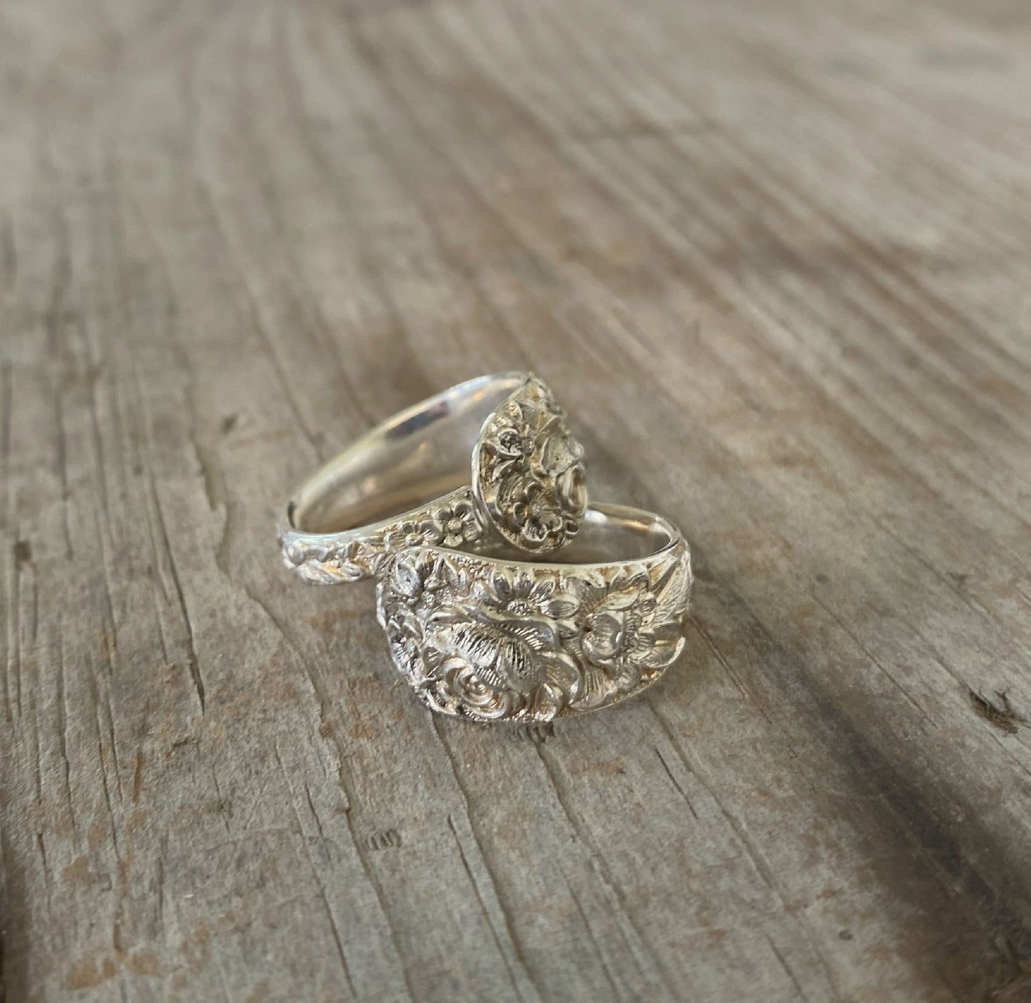 Pair of stacked Sterling silver Kirk & Son Repoussé spoon rings with deeply embossed continuous floral pattern from 1828 design