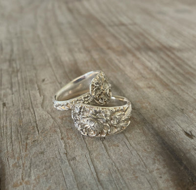 Pair of stacked Sterling silver Kirk & Son Repoussé spoon rings with deeply embossed continuous floral pattern from 1828 design