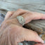 Antique Kirk & Son Repoussé sterling silver spoon ring on hand displaying ornate floral pattern