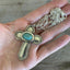 Handmade Cross Necklace Made from upcycled silverware handles  Shown In Hand for Scale