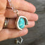 Silverware Necklace from Scrap Piece and Turquoise Colored Stone shown in hand for scale