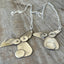 Close-up of dog lover necklace made from vintage silverplate spoon bowls