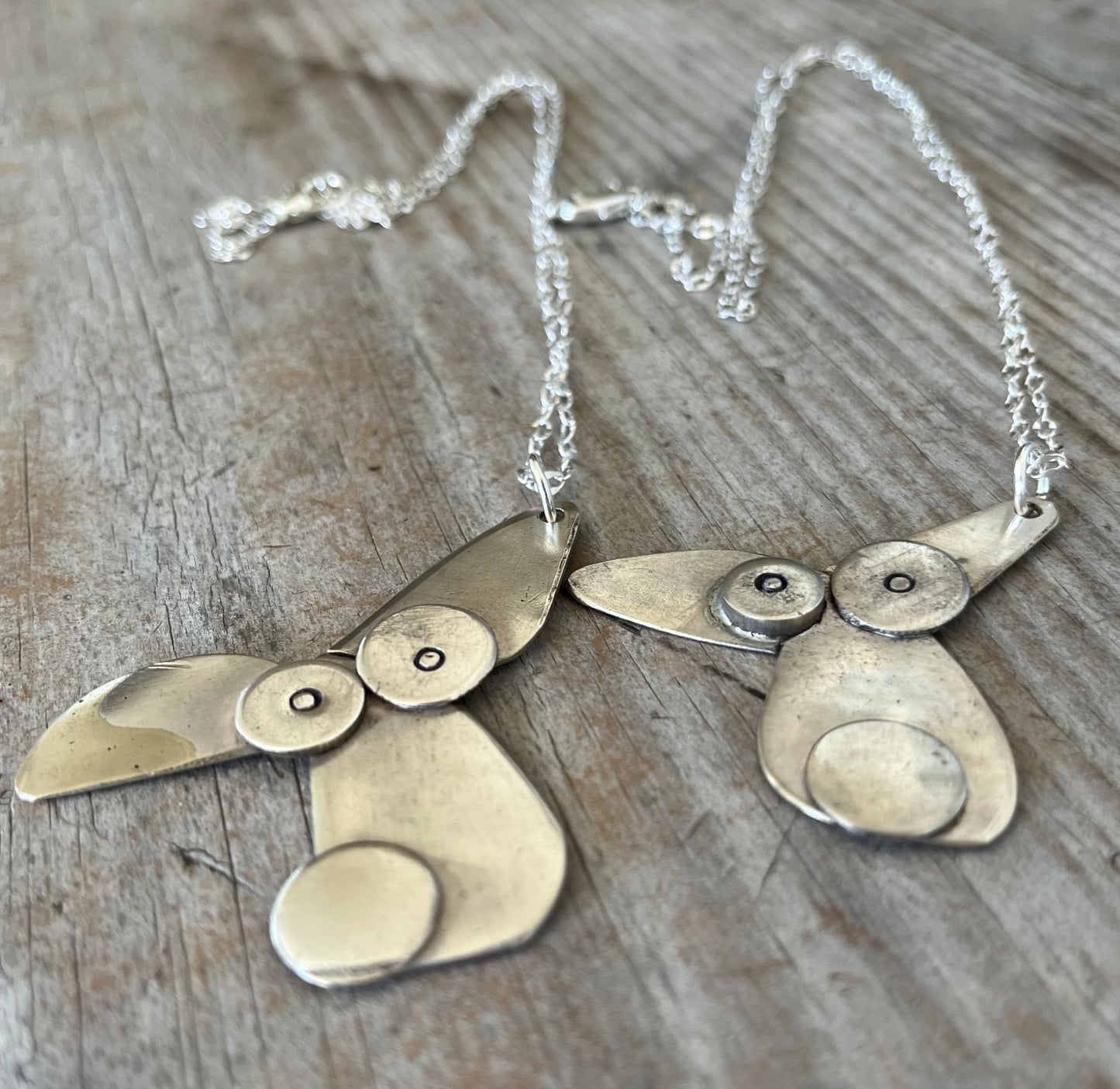 Close-up of dog lover necklace made from vintage silverplate spoon bowls