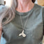 Vintage silverware puppy necklace shown on model - handmade artisan dog jewelry