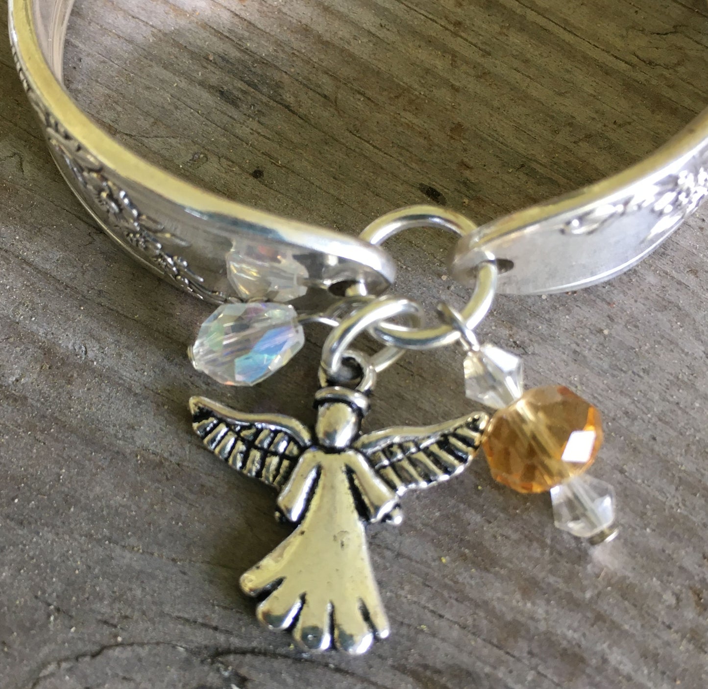 Close Up of Angel Charm on Spoon Bracelet with Angel Charm and Glass Beads 