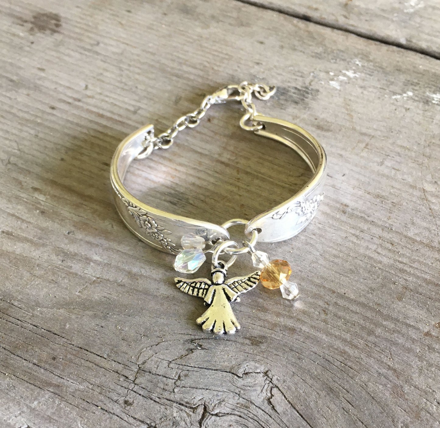 Close Up of Angel Charm on Spoon Bracelet with Angel Charm and Glass Beads 