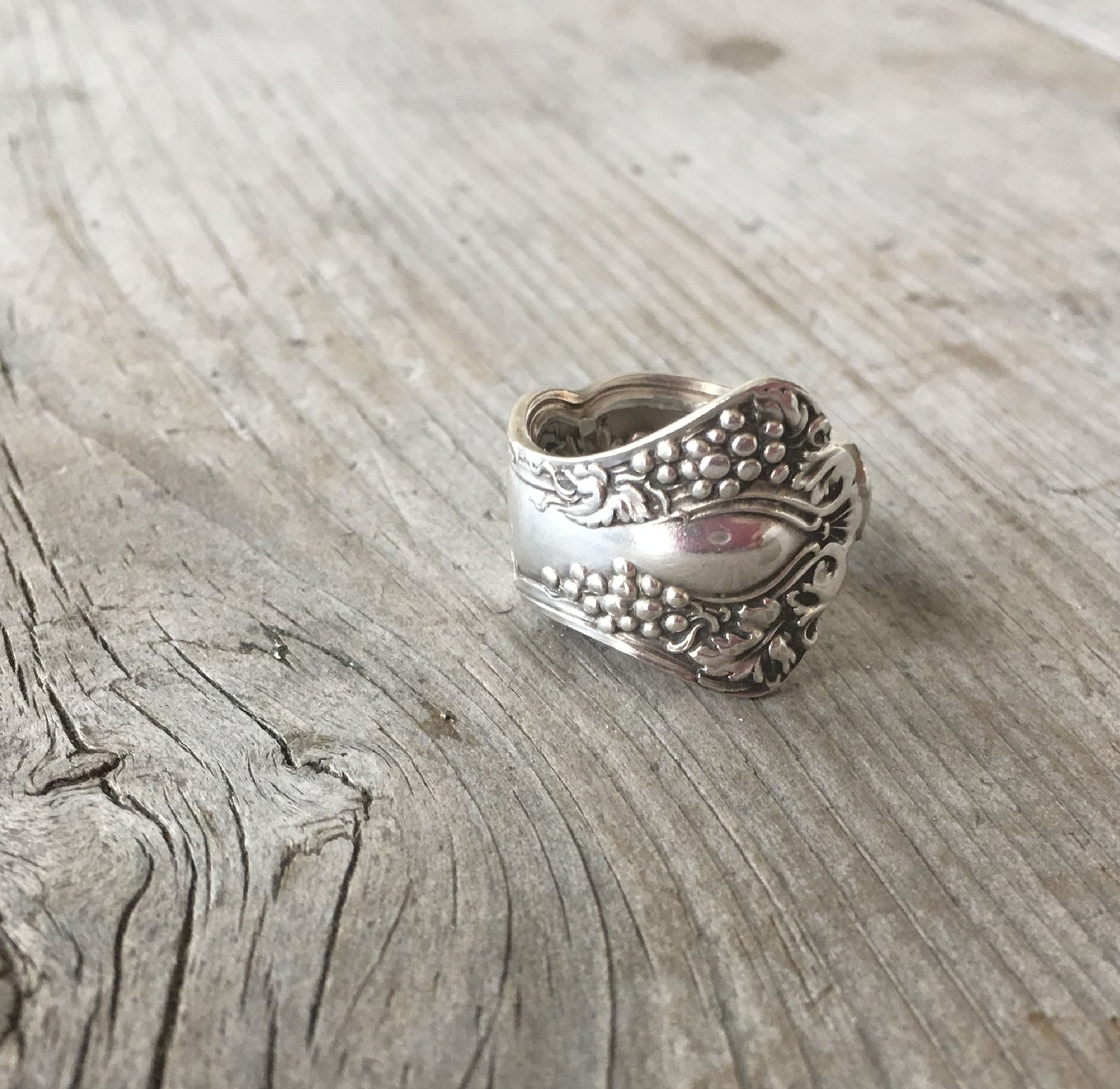 Detailed view of vintage grapes spoon ring showing curved band and grapes detail 