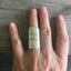 Upcycled spoon ring shown on model's hand