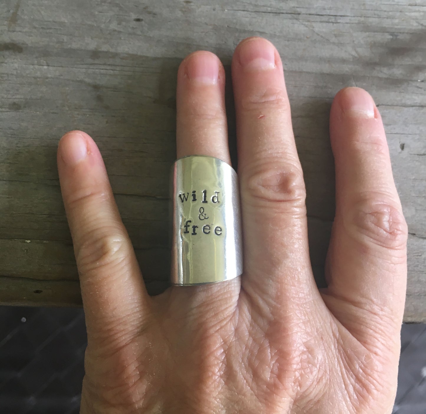 Upcycled spoon ring shown on model's hand