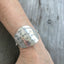 Stamped Spoon Upcycled spoon bracelet shown on model wrist