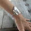 Stamped Spoon Upcycled spoon bracelet shown on model wrist