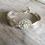 Upcycled silverware bracelet from two spoon handles and rhinestone button