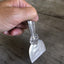handmade knife from vintage serving spoon shown in hand as demonstration
