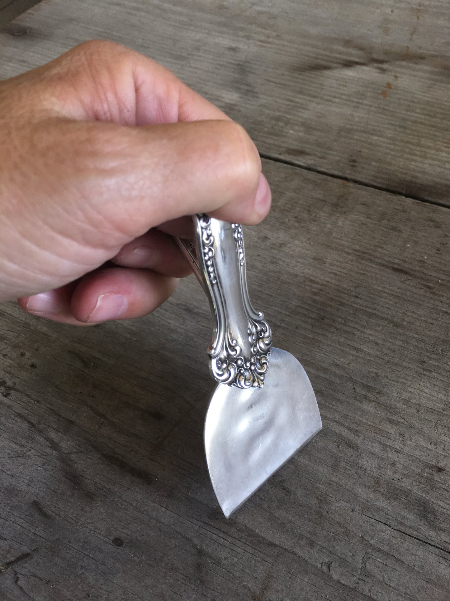 handmade knife from vintage serving spoon shown in hand as demonstration