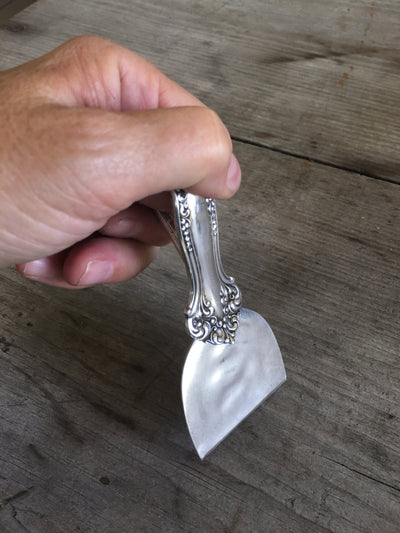 handmade knife from vintage serving spoon shown in hand as demonstration