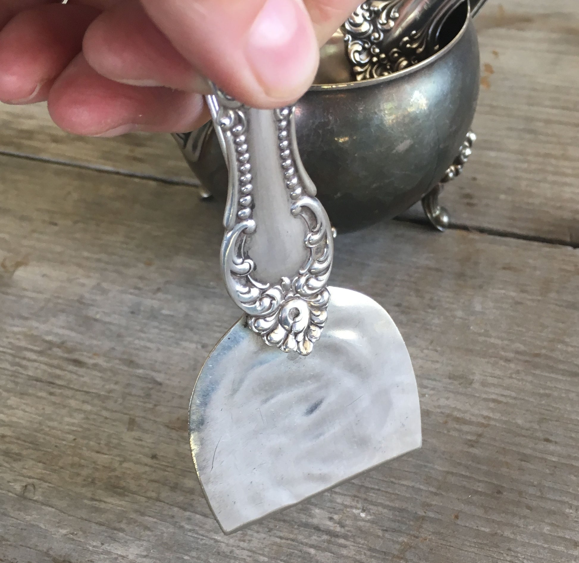 handmade knife from vintage serving spoon shown in hand as demonstration