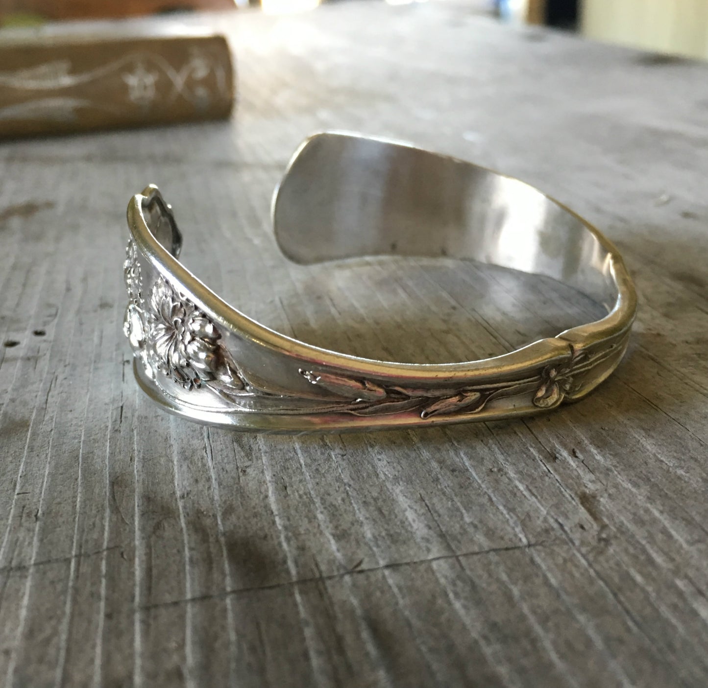 Carnation pattern spoon cuff bracelet side view showing floral detail - handcrafted from upcycled vintage silverware - Laughing Frog Studio