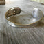 Carnation pattern spoon cuff bracelet angled view - handcrafted from upcycled vintage silverware - Laughing Frog Studio