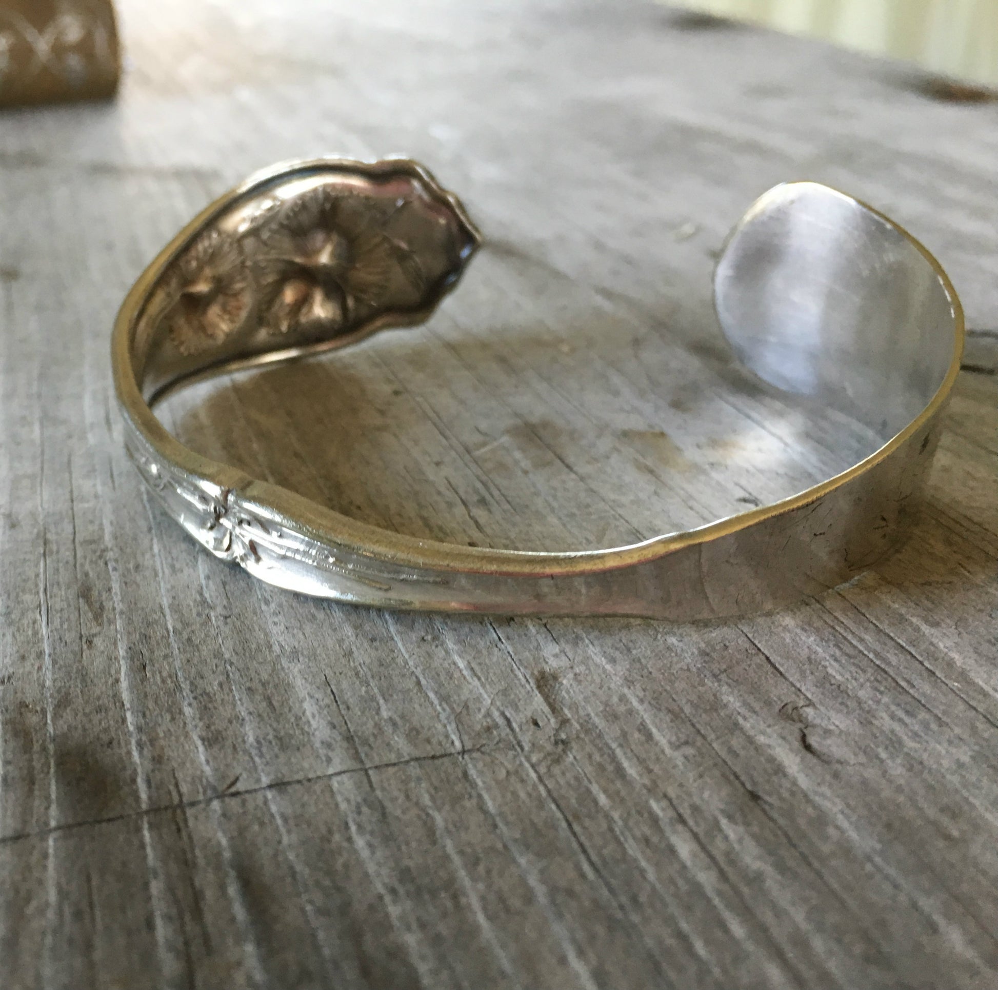 Carnation pattern spoon cuff bracelet angled view - handcrafted from upcycled vintage silverware - Laughing Frog Studio