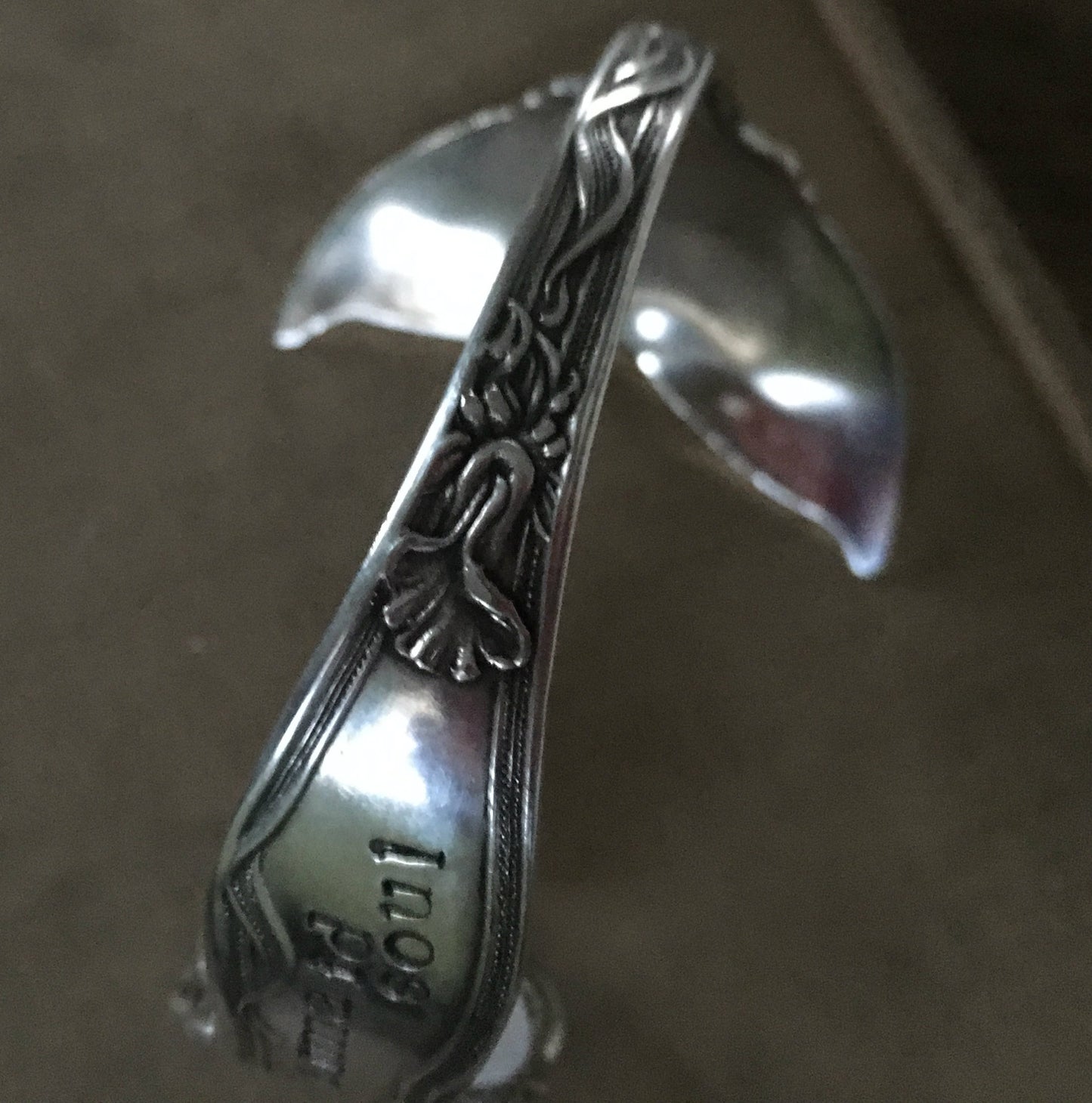 Unique view of the mermaid soul spoon cuff bracelet highlighting the detailed design
