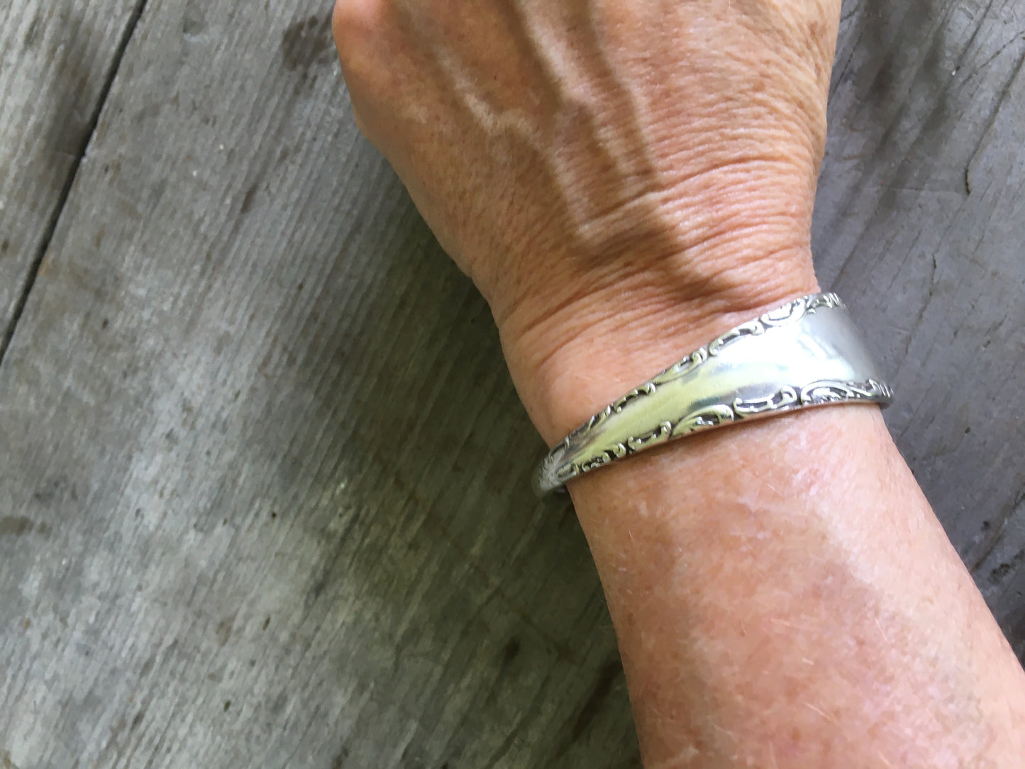 Handmade Spoon Cuff Bracelet from upcycled antique spoon shown on model