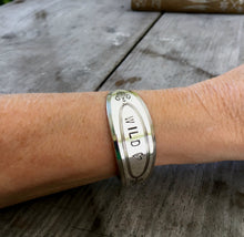 Wild heart cuff bracelet made from upcycled spoon shown on model wrist