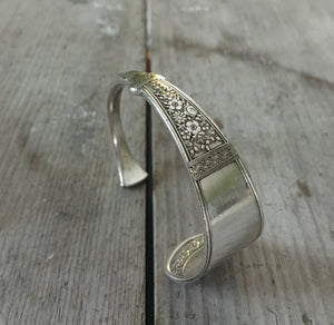 Cutlery bracelet from upcycled silverplate spoon with Victorian design shown standing upright