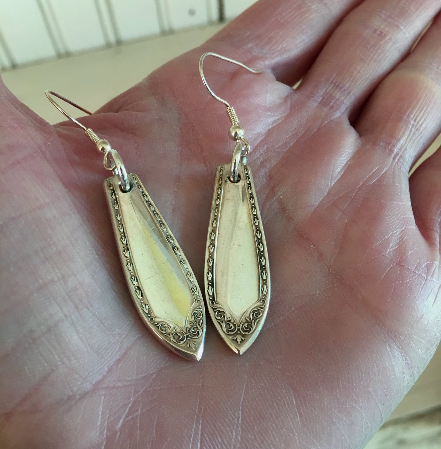 Spoon Handle Earrings In Sheraton Pattern Shown in hand for size scale