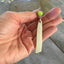South Seas Spoon Handle Earrings shown with hand for size scale