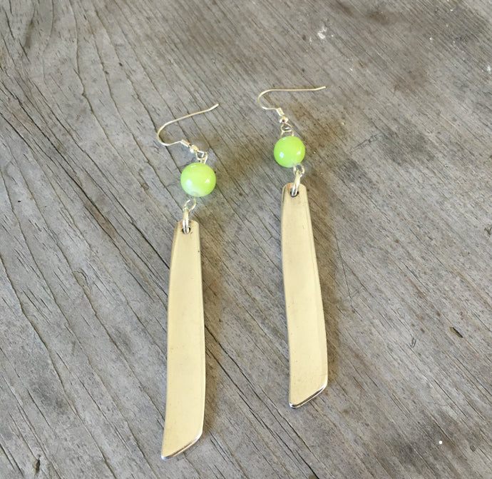 Earrings made from spoon handles in south seas pattern with chartreuse green bead