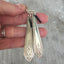 Art Deco Drexel Spoon Handle Earrings shown in hand for size and scale