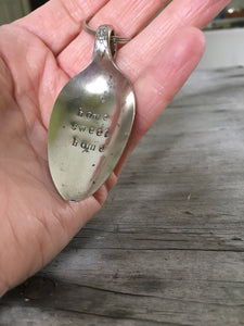 Home Sweet Home Keychain upcycled from vintage spoon shown in hand for size and scale