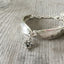 Silverware bracelet from upcycled spoon handles in the springtime pattern