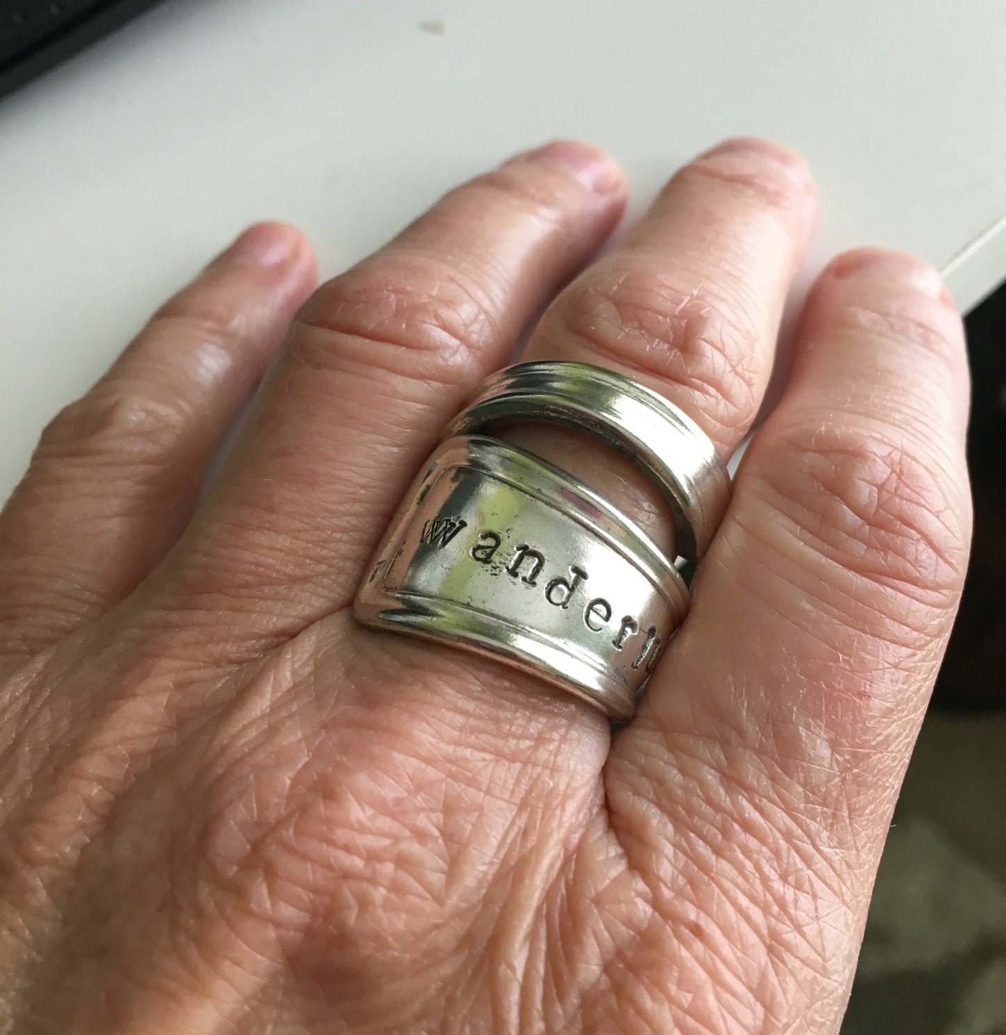 Wanderlust spoon ring shown on model