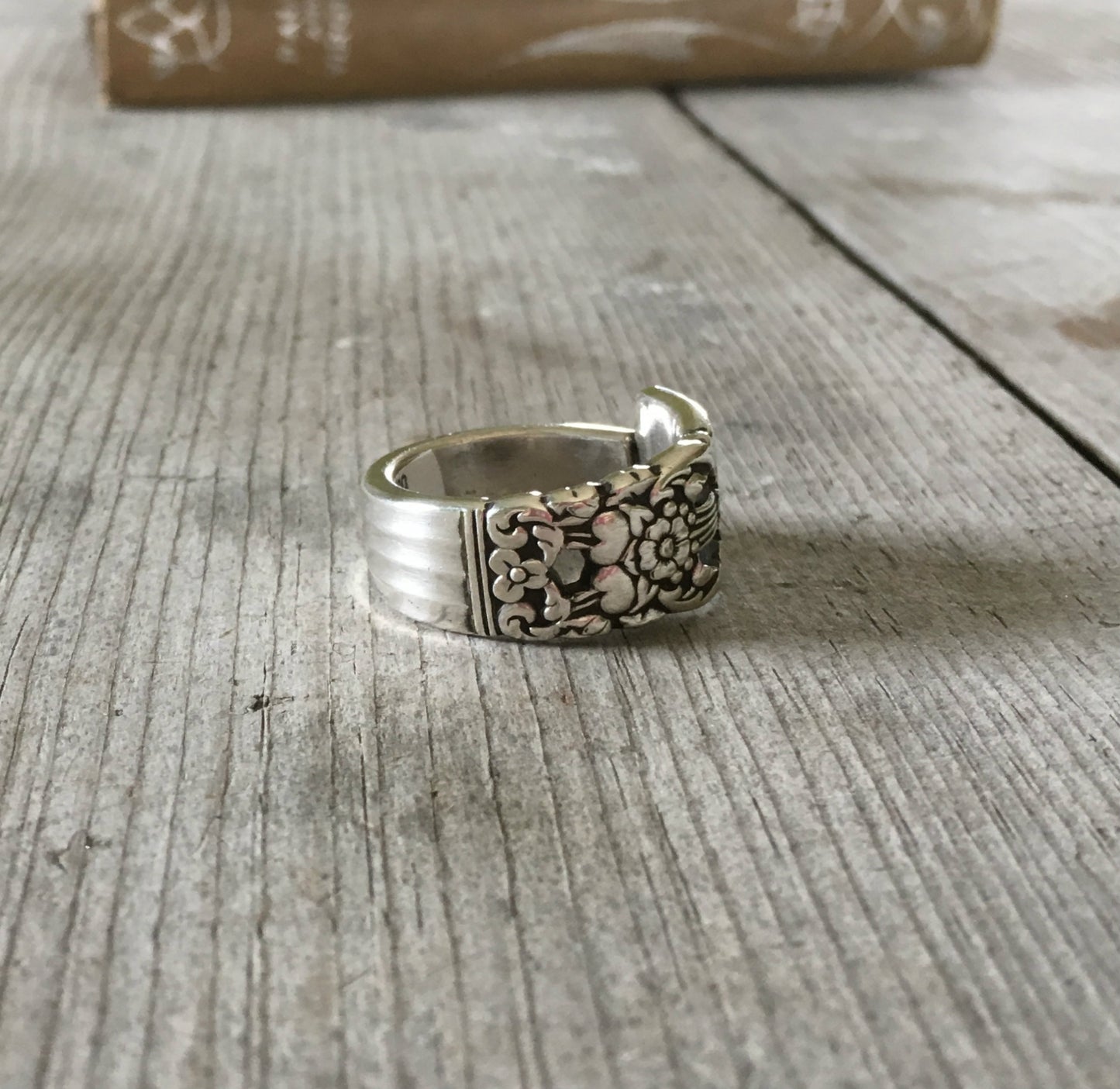 Side view of handmade CORONATION spoon ring showing curved band and artisan detail