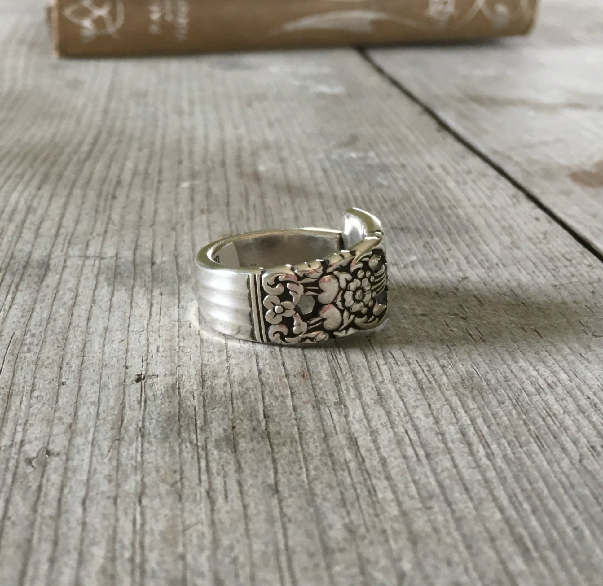 Side view of handmade CORONATION spoon ring showing curved band and artisan detail