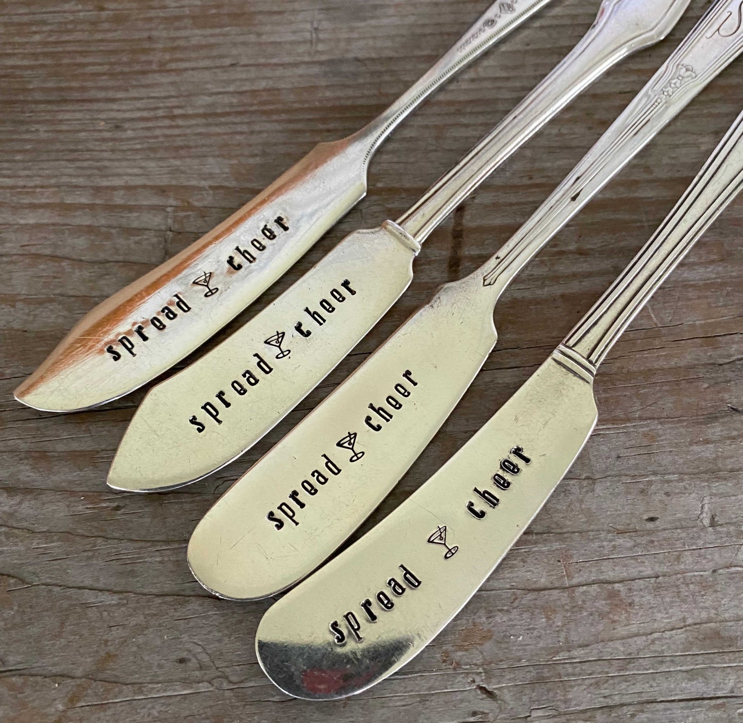 Detail of lettering on Antique silverware spreaders featuring Spread Cheer hand stamping - festive cheese board accessory