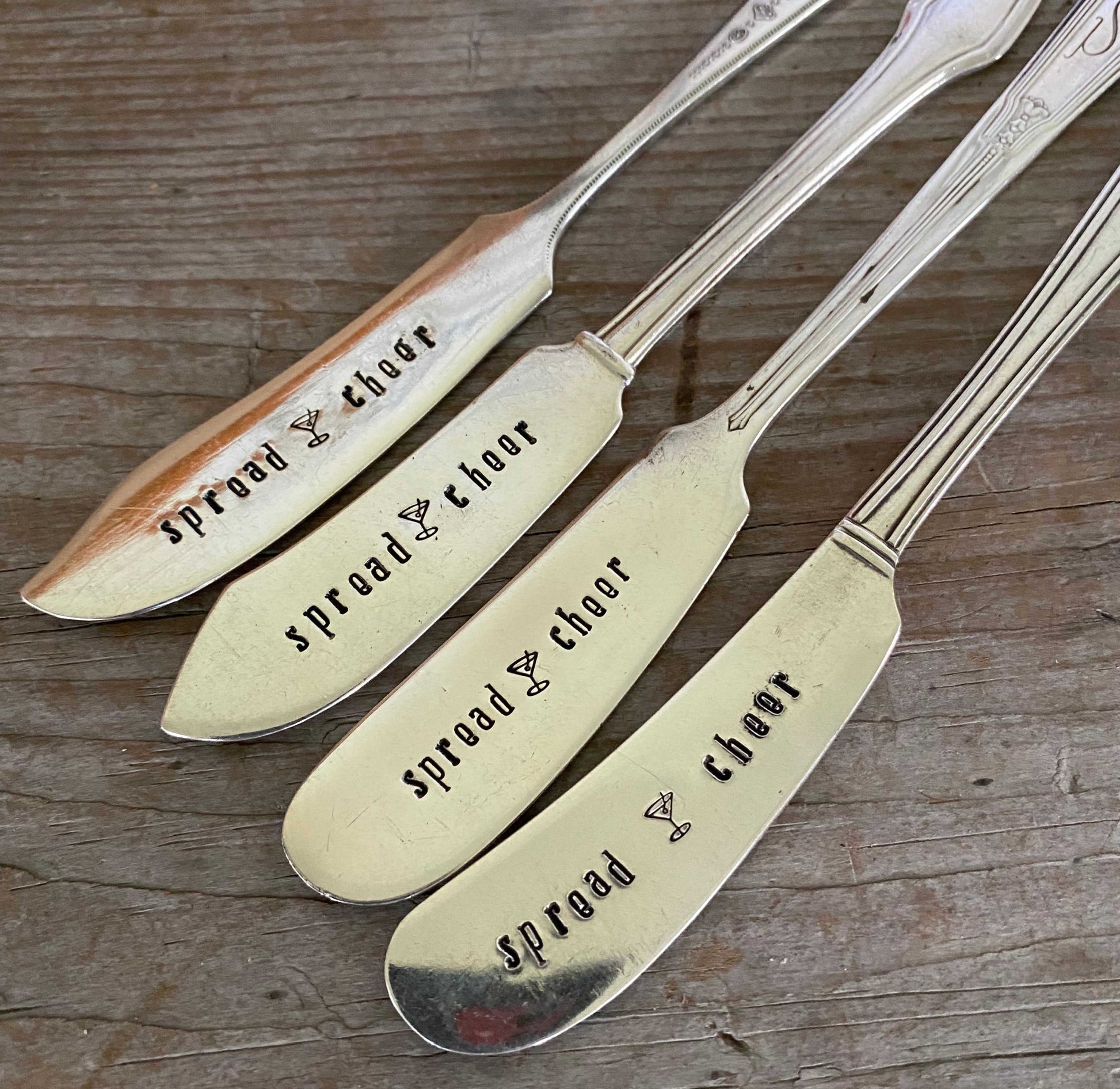 Detail of lettering on Antique silverware spreaders featuring Spread Cheer hand stamping - festive cheese board accessory