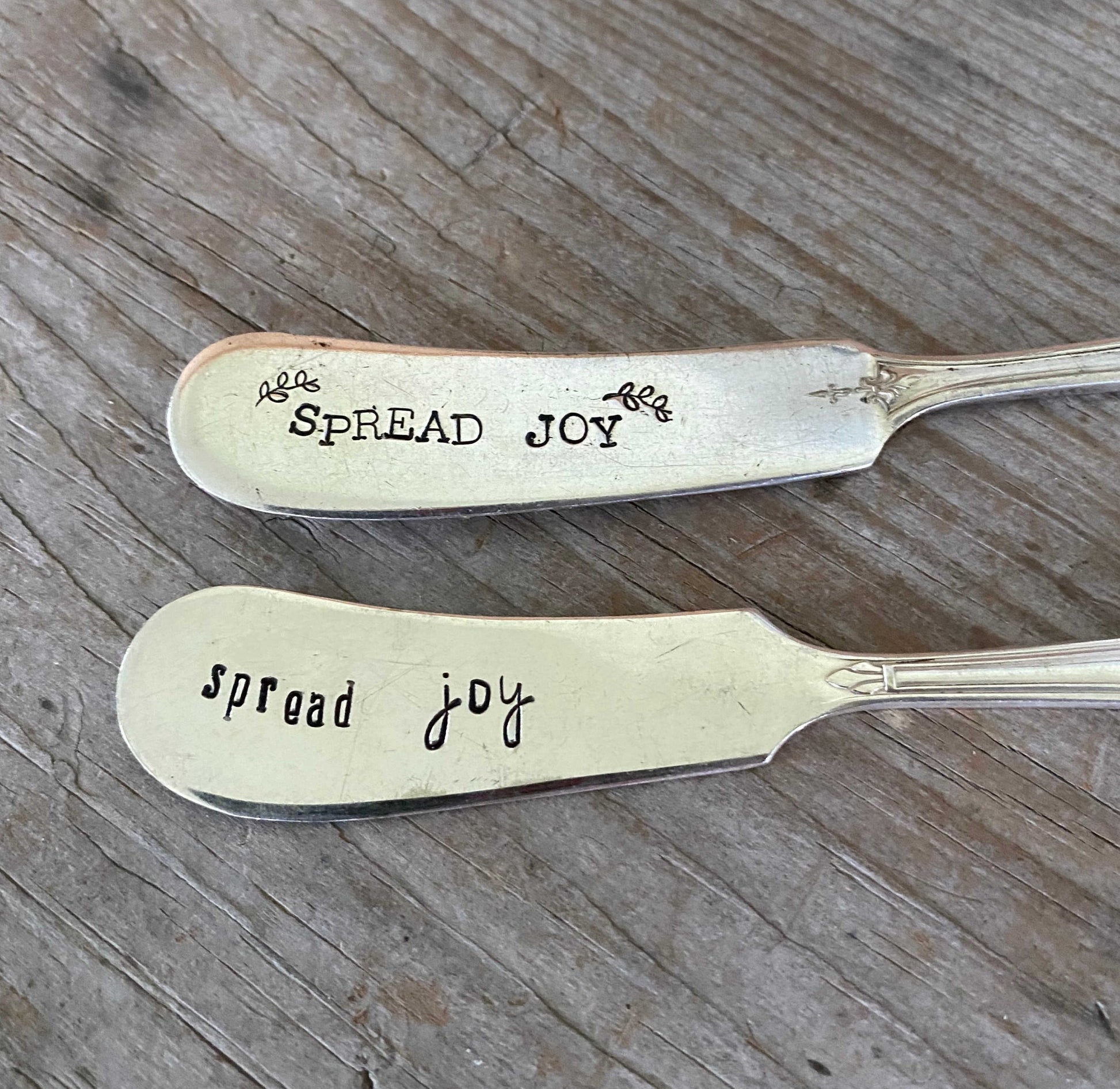 Close up of lettering on Vintage butter knives repurposed into Spread Joy cheese spreaders with hand-stamped lettering